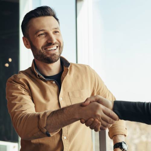 Freudiges Händeschüttlen zwischen Geschäftspartnern